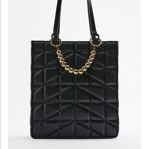 Sac matelassé petites boules sur le devant .Doubleur avec poche Bandoulièr